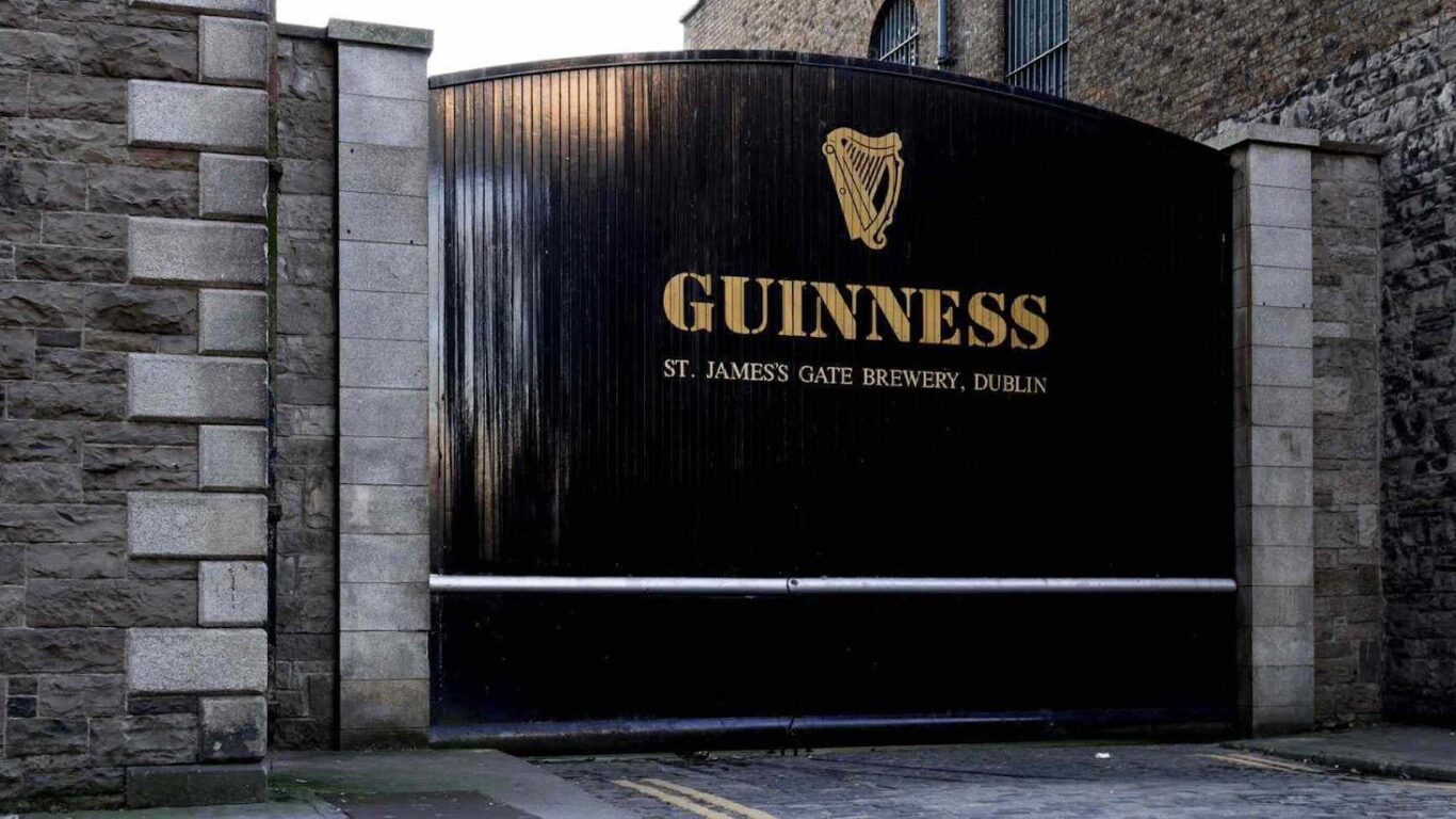 A large black gate with the Guinness logo and 
